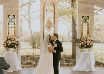 Bride and Groom kissing at the alter.