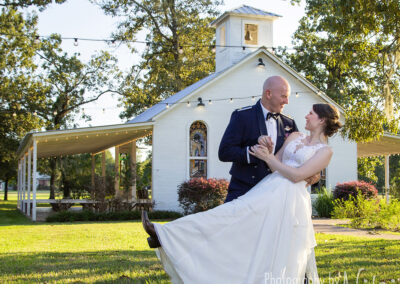 Image of the wedding couple celebrating in front of the chapel