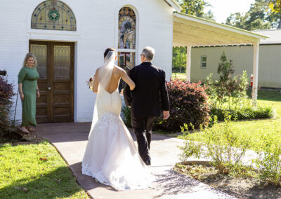 Father and daughter approaching the chapel on wedding day.