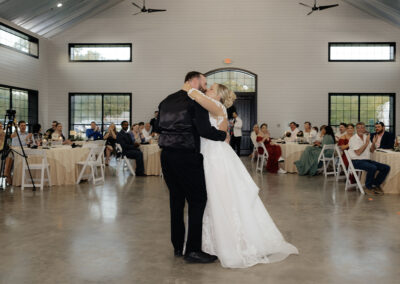 Wedding couple dancing inside the farmhouse for the reception.