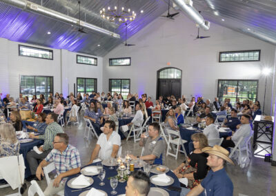 Indoor view of farmhouse full of people attending an event.