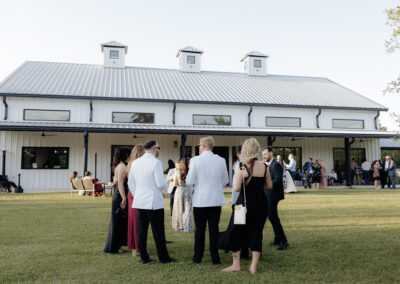 Outside view of the farmhouse showing people talking outside.