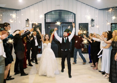 Newlyweds leave the reception to a sparkler celebration outside the farmhouse.